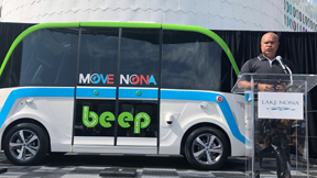 Beep Co-Founder Kevin Reid unveils the Beep autonomous shuttle, manufactured by NAVYA in Michigan.